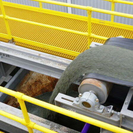 Intake system with hoppers, shuttle belt conveyor, FRP walkways, and platforms supplied by CIL Ltd for new masonry block plant in New Zealand.