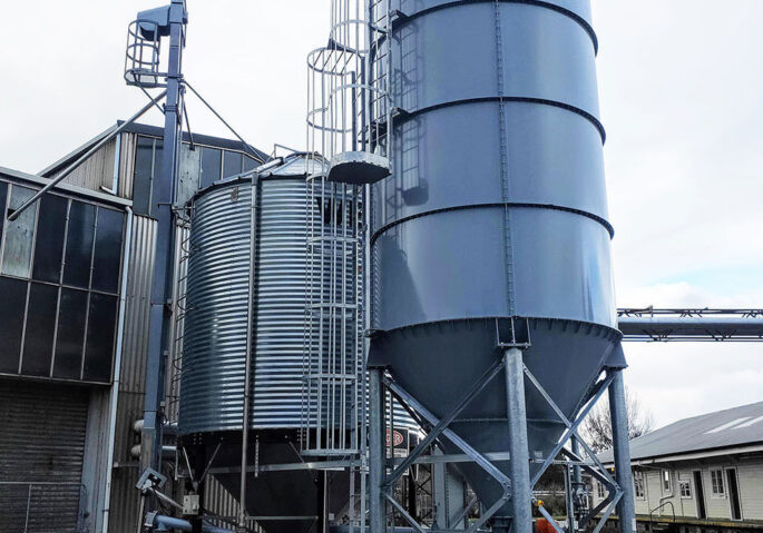 Silo storage and screw conveyor discharge system designed and installed by CIL Ltd for wood pellet fuel supply to a community boiler in New Zealand.